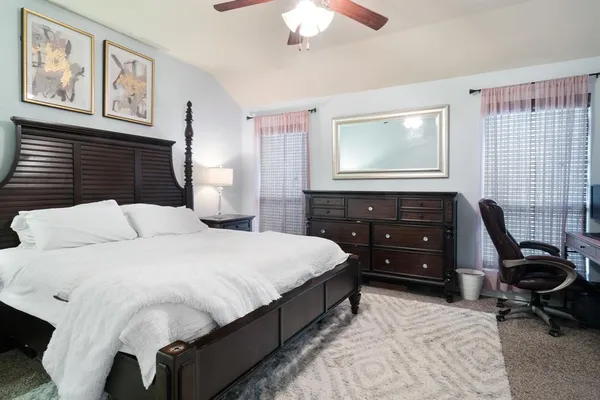 a bedroom with a bed and a dresser