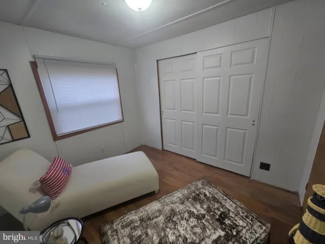 a bedroom with a bed and a mirror