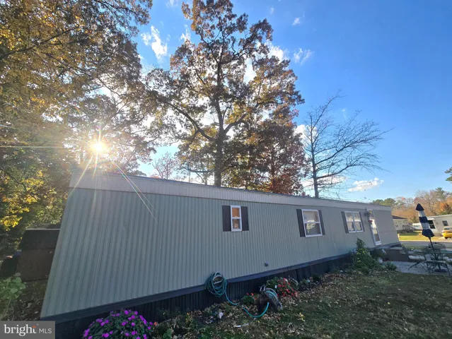 a view of a house with backyard sitting area and garden