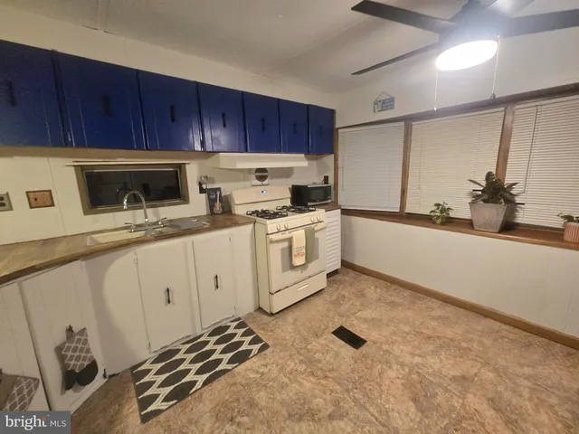 a kitchen with stainless steel appliances a stove a sink and a refrigerator with wooden cabinets