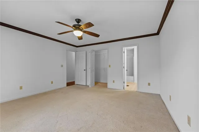 a view of empty room with ceiling fan