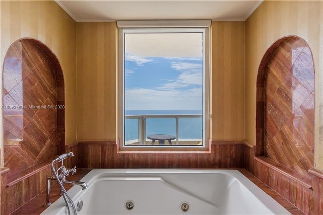 a bathroom with a tub and a sink