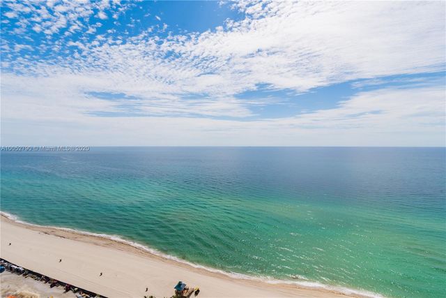 a view of a yard with an ocean view