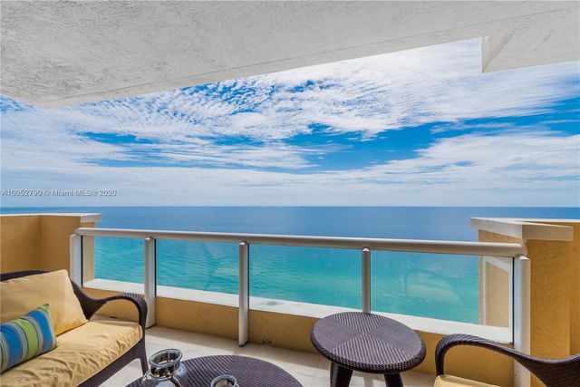 a balcony with table and chairs