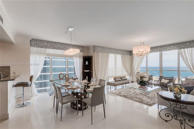 a view of a dining room with furniture window and outside view
