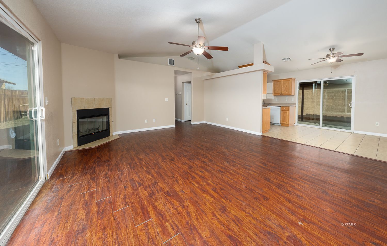 1237 West Boston Avenue Ridgecrest, CA 93555 - Photo 2 of 32 a view of an empty room with wooden floor fireplace and a window