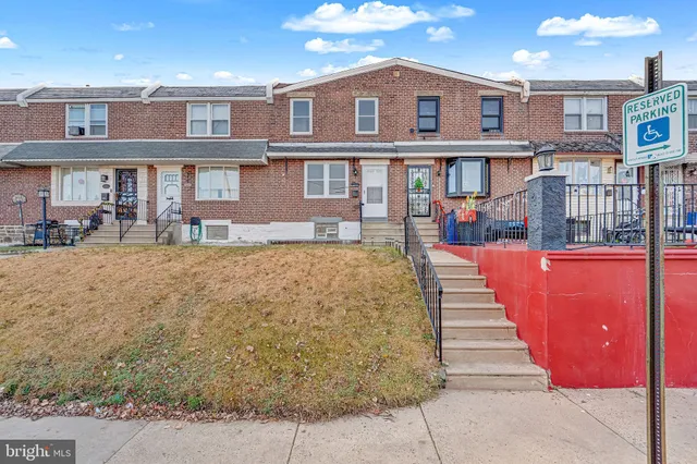 a front view of a brick building with many windows