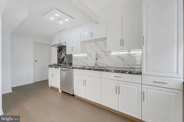 a kitchen with white cabinets