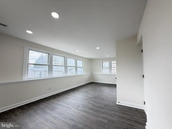 a kitchen with refrigerator and cabinets