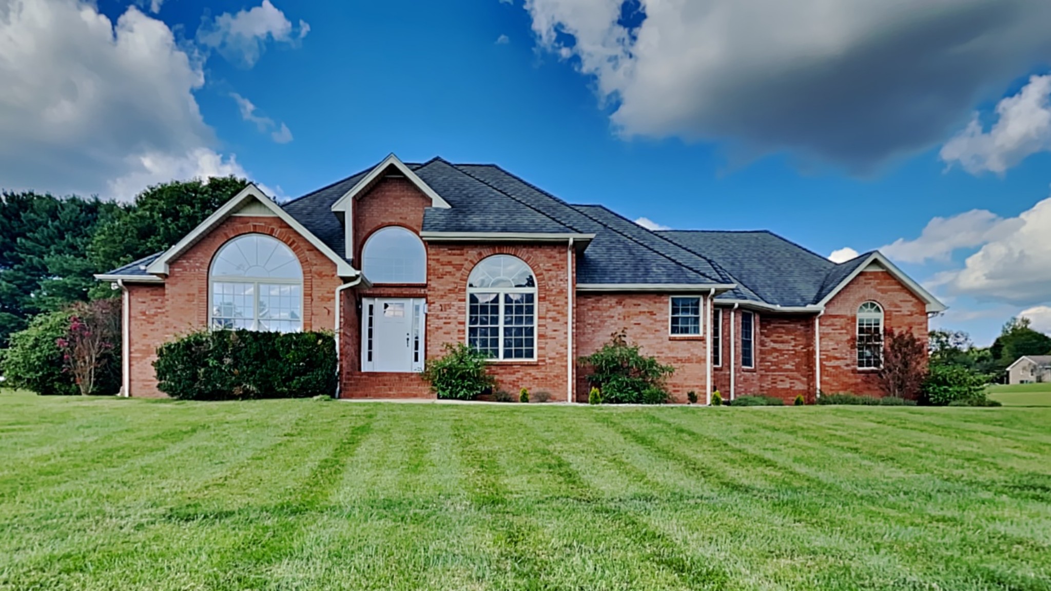 a front view of a house with a yard