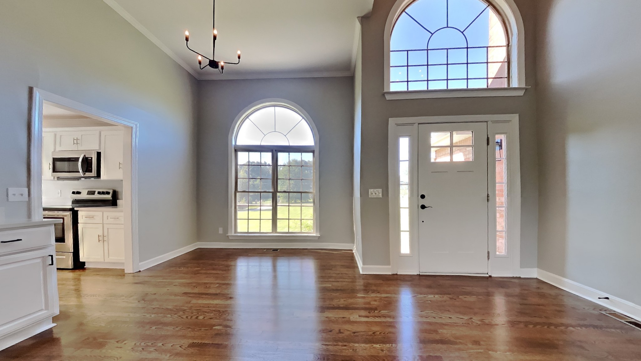 1024 Nina Drive Springfield, TN 37172 - Photo 2 of 16 an empty room with wooden floor cabinet and a kitchen