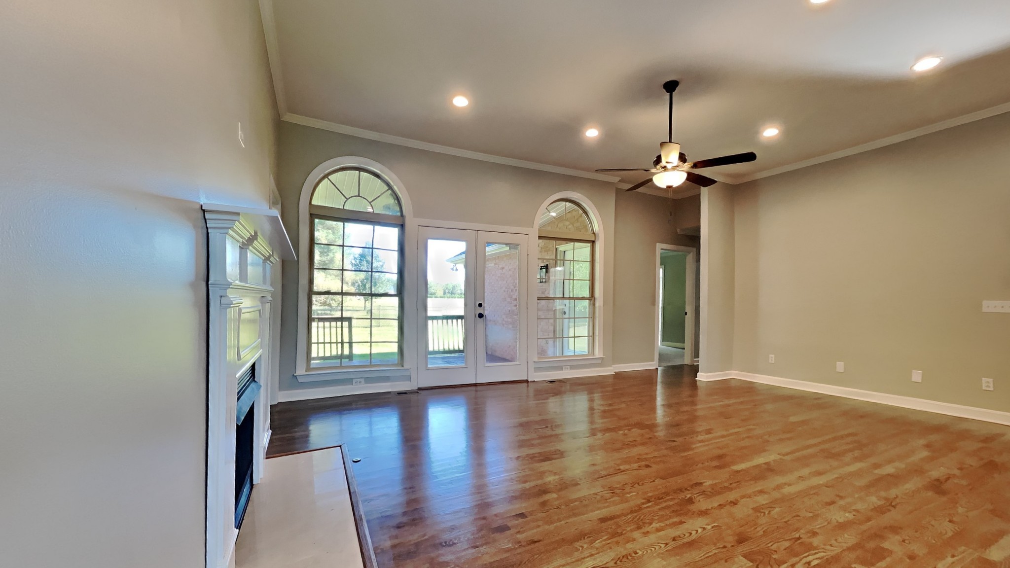 1024 Nina Drive Springfield, TN 37172 - Photo 4 of 16 an empty room with wooden floor fan and windows