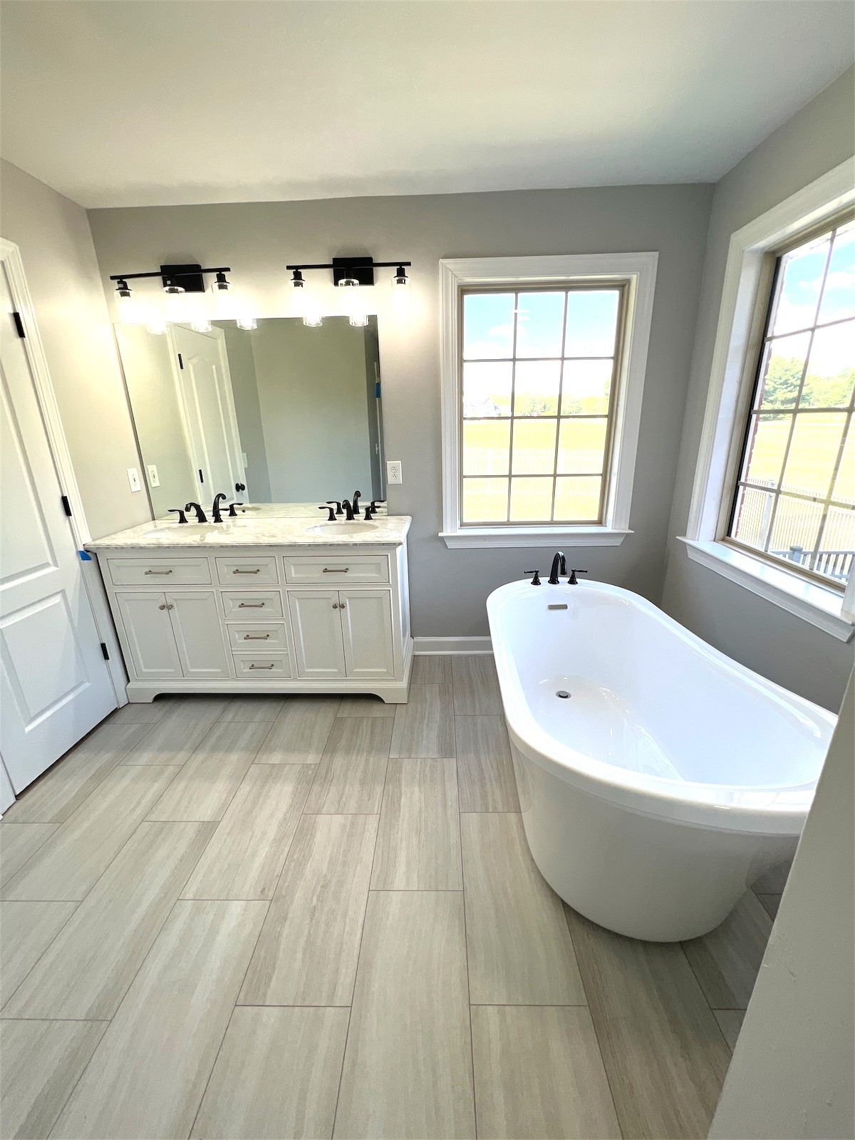 1024 Nina Drive Springfield, TN 37172 - Photo 9 of 16 a spacious bathroom with a tub double vanity sink and mirror