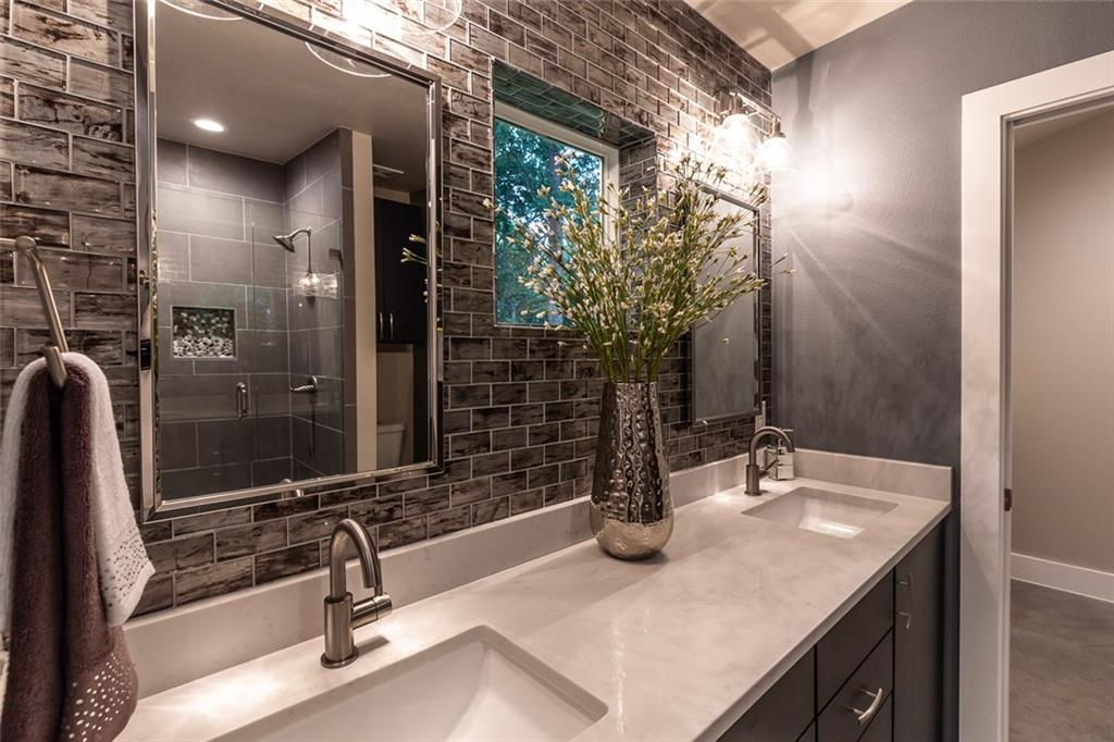1142 Eleanor Street, Unit 2 Austin, TX 78721 - Photo 15 of 24 Twin vanities and gleaming fixtures create a refreshed, modern bathroom sanctuary.