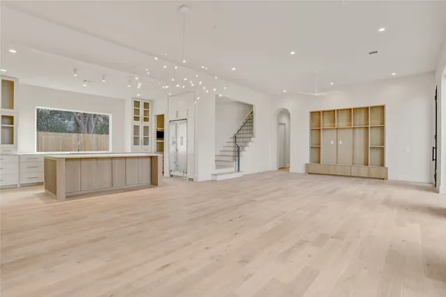 a view of an empty room with a kitchen