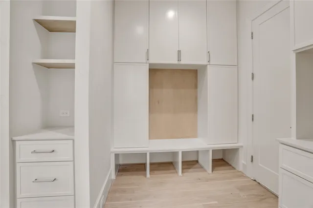 a view of an empty room with a fireplace and a window