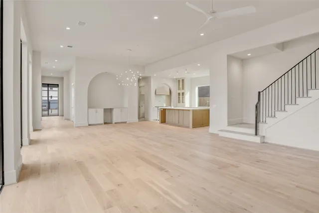 a view of empty room with wooden floor and windows