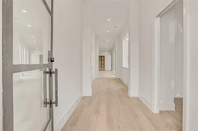 a view of a hallway with wooden floor