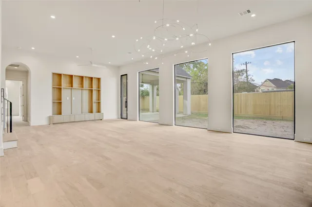 a view of empty room with cabinet and window