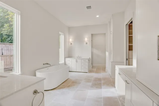 a bathroom with a bathtub and a shower