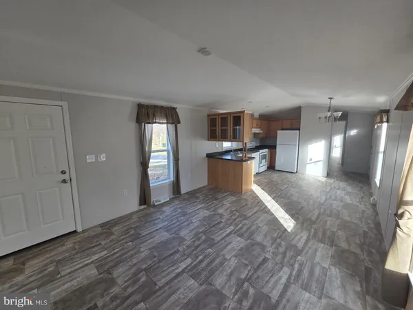 a large room with wooden floor and windows