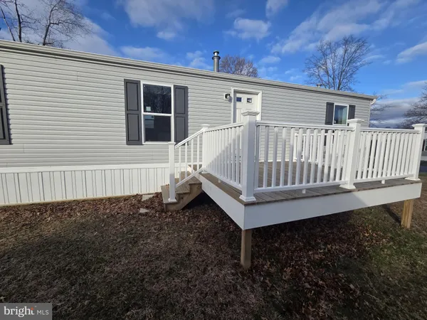 a view of a house with wooden fence