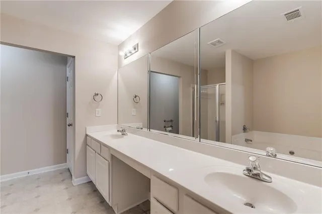 a bathroom with a shower and a glass door