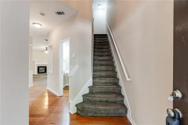 a view of an empty room with window and fire place