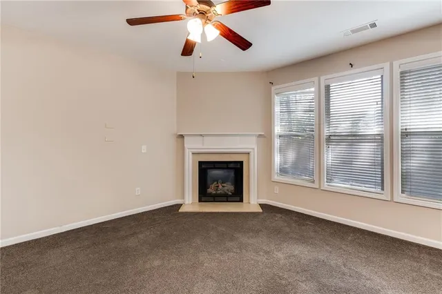 a view of kitchen with stainless steel appliances kitchen island a fireplace