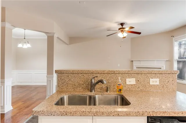 a kitchen with granite countertop a stove top oven microwave and cabinets