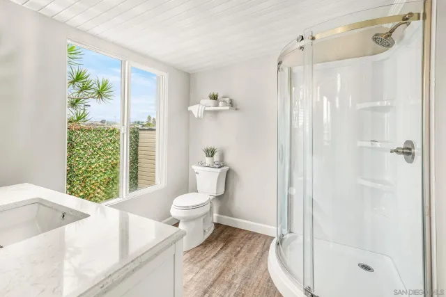 a bathroom with a sink toilet and shower
