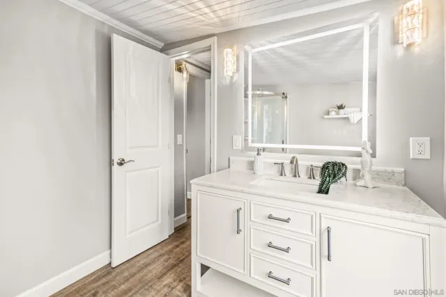 a bathroom with a granite countertop sink mirror and