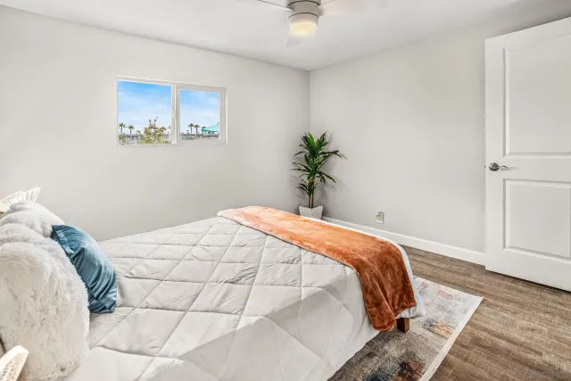 a bedroom with a bed and a painting on the wall