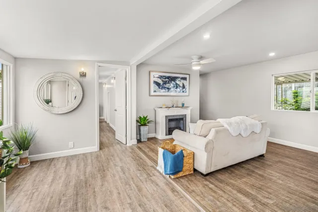 a living room with furniture a window and a fireplace