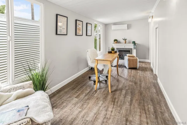 a dining room with furniture and wooden floor