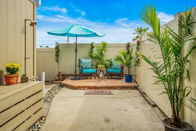 a view of a patio with swimming pool table and chairs