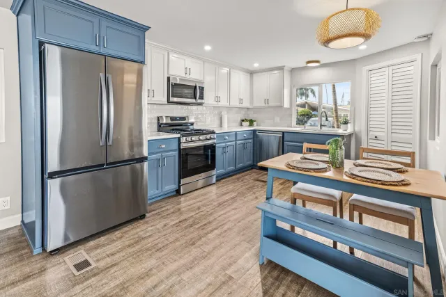 a kitchen with stainless steel appliances granite countertop a refrigerator stove microwave and sink