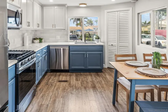 a kitchen with granite countertop wooden floors and sink