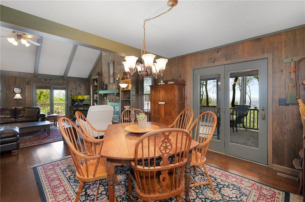 1339 Ridgeview Drive Big Canoe, GA 30143 - Photo 38 of 78 a dining room with furniture a chandelier and wooden floor