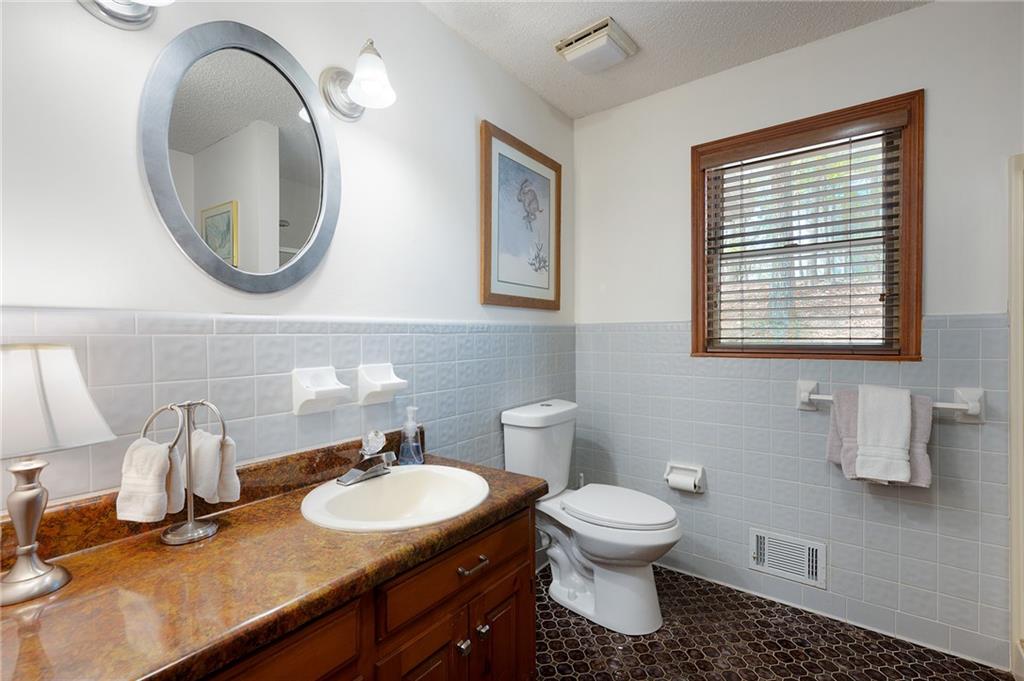 1339 Ridgeview Drive Big Canoe, GA 30143 - Photo 63 of 78 a bathroom with a toilet sink and mirror