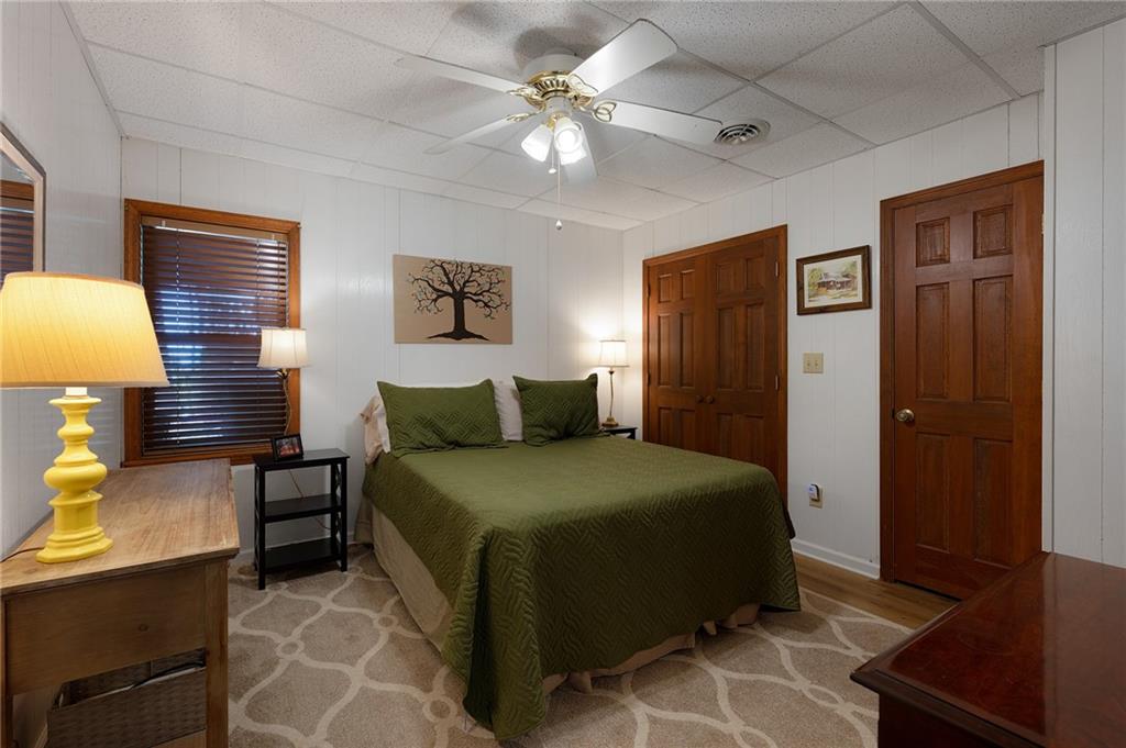 1339 Ridgeview Drive Big Canoe, GA 30143 - Photo 67 of 78 a bedroom with a bed and a lamp on dresser