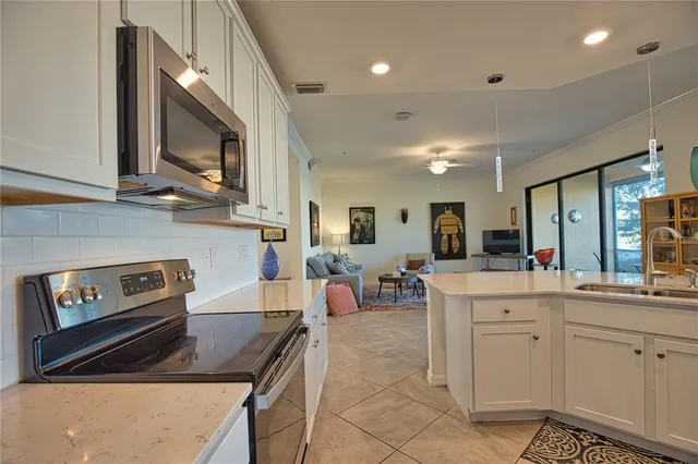 a kitchen with furniture a stove and a view of living room