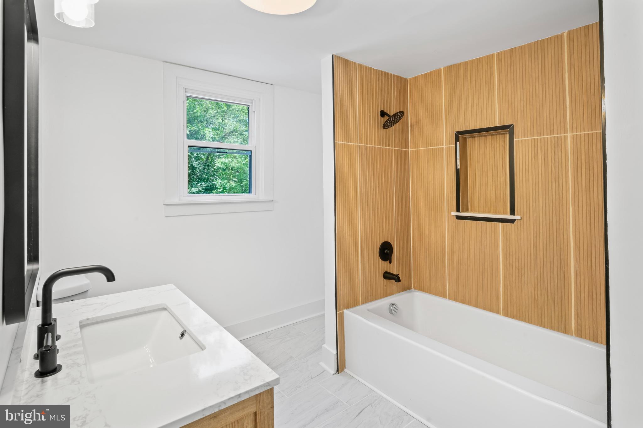 583 Orchard Road Carneys Point, NJ 08069 - Photo 60 of 62 a bathroom with a tub a sink and a window