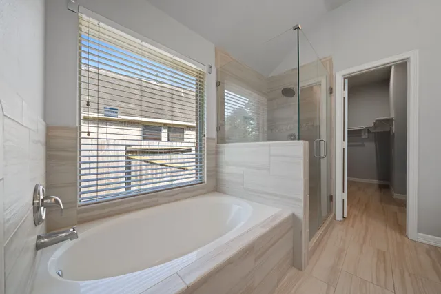 a bathroom with a tub and a shower