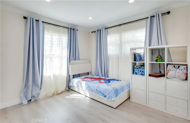 a bedroom with a bed and a window