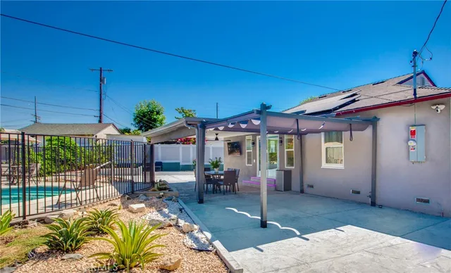 a view of a patio with table and chairs under an umbrella