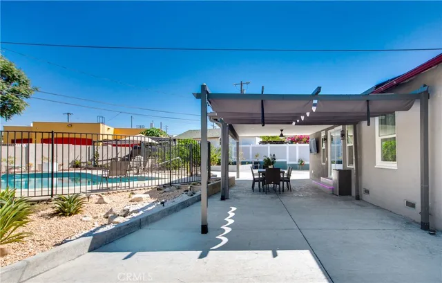 a view of a patio with a table and chairs