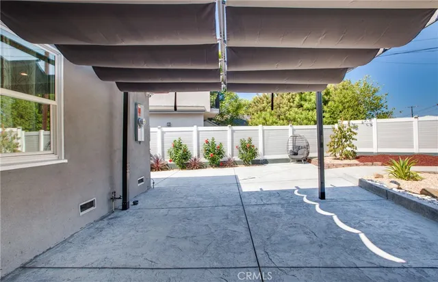 a view of a patio with table and chairs potted plants