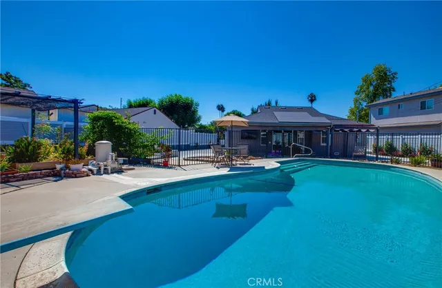 a swimming pool view with a seating space