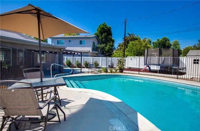 a view of a patio with chairs and potted plants
